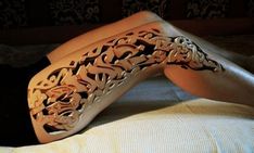 tattoo art is real or fake on someone's leg and foot in the bed