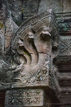 an intricate carving on the side of a stone building in angboid, indonesia