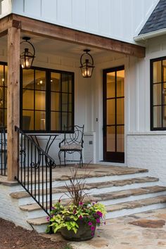 a porch with steps leading up to the front door