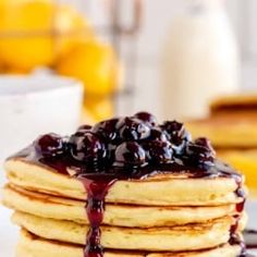 a stack of pancakes covered in blueberry syrup