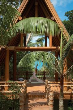 a wooden gazebo surrounded by palm trees