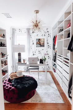 a living room filled with lots of white furniture and walls covered in bookshelves