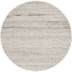 a round rug with grey and white stripes