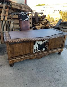 an old wooden bench with cowhide upholstered on it