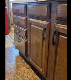 a kitchen counter top with wooden cabinets and drawers