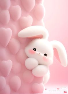 a white bunny is peeking out from behind a pink wall with hearts in the background