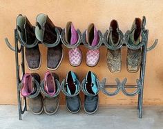 there are many pairs of shoes hanging on the wall next to a rack with them