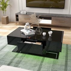 a living room with a black coffee table in front of a flat screen tv