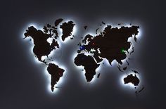 an illuminated world map is shown in the dark with white lights on it's sides