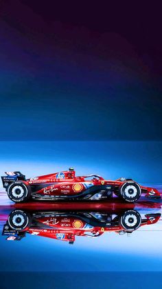 a red race car is reflected in the water