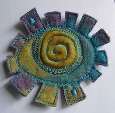 a close up of a piece of felt with a spiral design on the center and sides