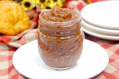 a jar of peanut butter sitting on top of a white plate