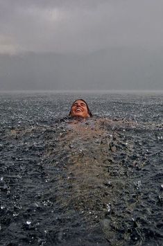 a person floating in the water with their eyes closed