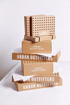 four boxes stacked on top of each other with the words urban outfitters printed on them