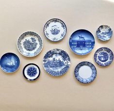 blue and white plates are arranged on the wall