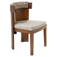 a wooden chair with a cushion on the back and seat pad in front of it