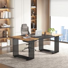 an office desk with a laptop on it in front of a book shelf filled with books