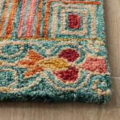 a multicolored area rug with an intricate design on the top and bottom corner