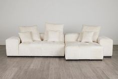 a white couch sitting on top of a hard wood floor