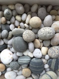 a box filled with lots of different colored rocks