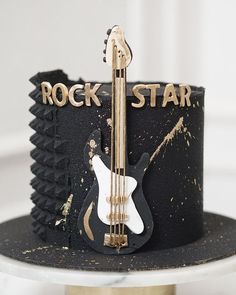 a rock star themed cake with a guitar on top