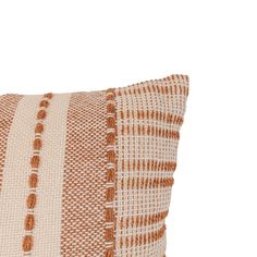 an orange and white striped pillow on a white background