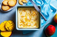 a bowl of ice cream next to some fruit and crackers