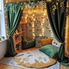 a room with green curtains and lights on the ceiling, in front of a bed