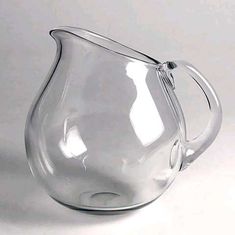 a clear glass pitcher sitting on top of a table