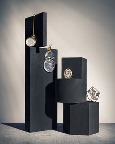 three pieces of jewelry sitting on top of each other in front of a gray background