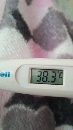 a digital thermometer sitting on top of a blanket