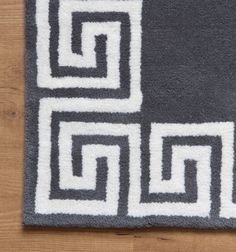 a blue rug with white squares on the top and bottom, along with an interlocked design