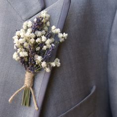 a boutonniere with flowers attached to the lapel of a suit jacket