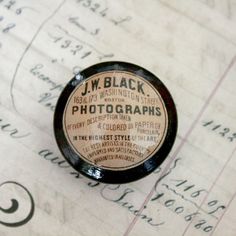 a close up of a bottle cap on top of a piece of paper