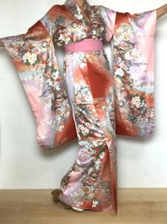 A woman's long sleeve Furisode Kimono. Sash sold separately. Japanese vintage dress with butterfly & floral pattern in metallic gold, coral and seashell colors. Fits a USA size S. International Express Shipping includedsee below) MATERIAL: Silky synthetic.   PATTERN:  Flowers and Butterflies.   COLORS:  Toasted coral orange, seashell pink, blue and purple, sage and olive green.  DETAILS:  Metallic gold overlay on design.   CONDITION:  Used, vintage.  Good condition. Belt NOT included. Kimono Sas Kimonos, Purple And Gold Kimono, Sage And Olive Green, Small Kimono, Lunar Festival, Cultural Clothing, Furisode Kimono, Seashell Pink, Cute Kimonos