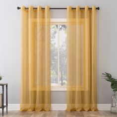 The light and airy No. 918 Emily Voile Sheer Grommet Curtain Panel gently captures light and brings modern elegance to the windows of any living space. Equipped with built-in silver metal grommets for easy hanging on curtain rods up to 1-1/2" in diameter, No. 918 Emily Voile Sheer Grommet Curtain Panel can be used alone or as an added layering piece for added privacy or a more lush look. Sold as individual panels measuring 59" width by 84" length in color curry yellow. Measure carefully before selecting your desired size and quantity. Rod not included. Machine wash cold on gentle cycle. Use non-chlorine bleach when needed. Tumble dry on low heat, using a cool iron as needed. No. 918 84-in Curry Yellow Sheer Grommet Single Curtain Panel | 58778 Yellow Gold Curtains, Curry Yellow, Yellow Curtains, Grommet Panels, Gold Curtains, Sheer Curtain Panels, Colorful Curtains, Grommet Curtains, Sheer Curtain