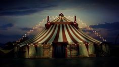 a large circus tent with lights on it