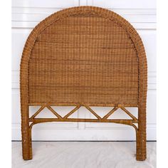 a wicker headboard with an arched top