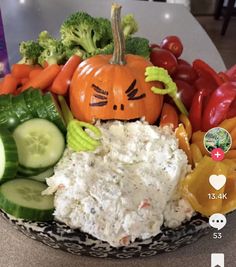 a bowl filled with rice and vegetables sitting on top of a table next to a cell phone