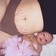 a baby laying on top of a bed wearing a diaper