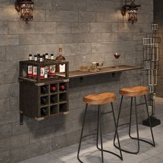 two wooden stools sitting in front of a bar with bottles on top of it