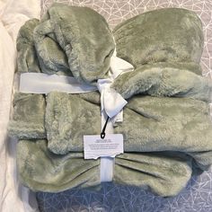 two towels folded up on top of each other with a price tag attached to them