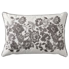 a black and white pillow with flowers on it