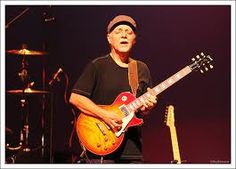 a man playing an electric guitar on stage