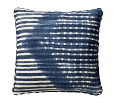 a blue and white pillow that has been dyed with an ombretta pattern on it