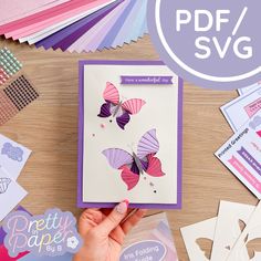 a hand holding a card with paper butterflies on it and the words pretty paper club next to it