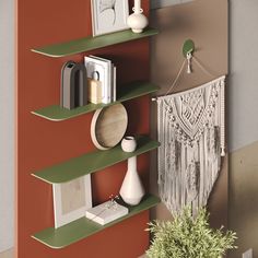 the shelves are green and brown with pictures on each shelf, vases and other items