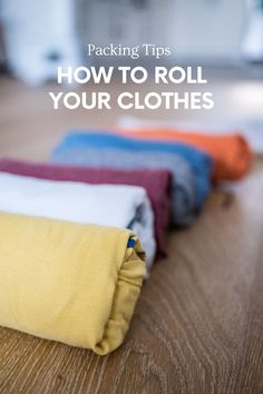 folded cloths sitting on the floor with text overlay reading packing tips how to roll your clothes