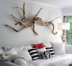 a living room filled with white furniture next to a window