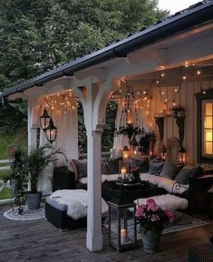 an outdoor living area with couches and lights